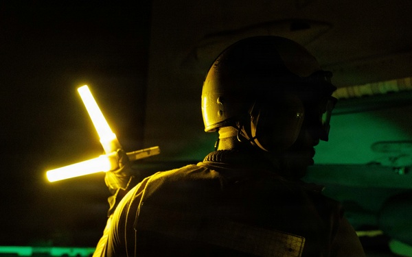 USS George H.W. Bush signals an F/A-18E Super Hornet