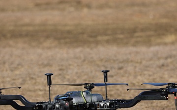 A UAS drone prepares for liftoff in a field during a technical training exercise.
