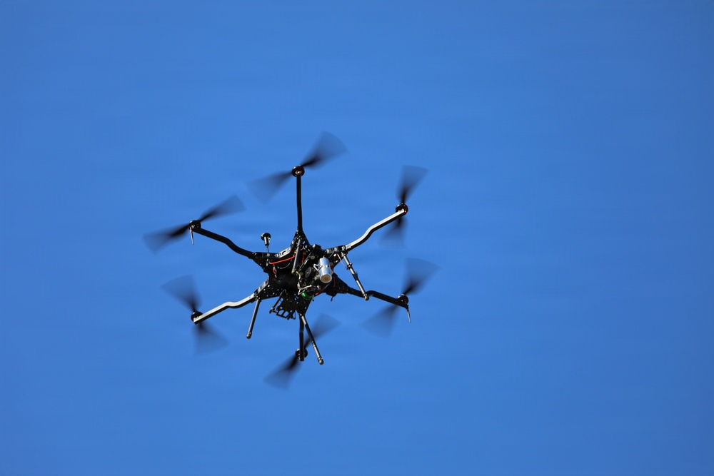 Multi-Rotor UAS Drone in Flight Against Clear Blue Sky