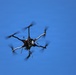 Multi-Rotor UAS Drone in Flight Against Clear Blue Sky