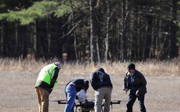 Technicians Prepare Large Multi-Rotor Drone for Flight Operations at Open Field Test Site