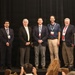 USACE employees pose on stage at SAVE International conference after receiving awards.