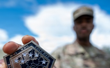Staff Sgt. Makonnen Francis poses with a V Corps' Coin (Rear)