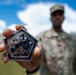 Staff Sgt. Makonnen Francis poses with a V Corps' Coin (Rear)