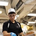USS George H.W. Bush Sailor seasons chicken