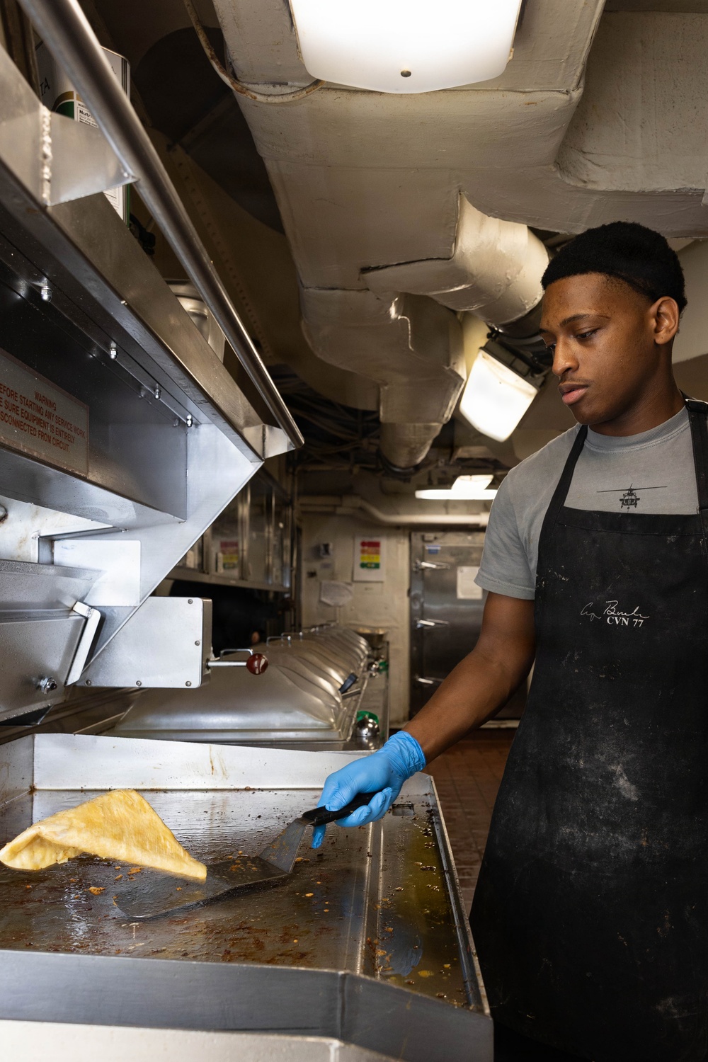 USS George H.W. Bush Sailor prepares food