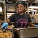 USS George H.W. Bush Sailor transfers food to a serving tray
