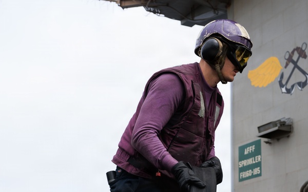 USS George H.W. Bush Sailor transports a fuel hose