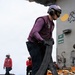 USS George H.W. Bush Sailor transports a fuel hose