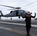 USS George H.W. Bush signals the launch of an MH-60R Sea Hawk