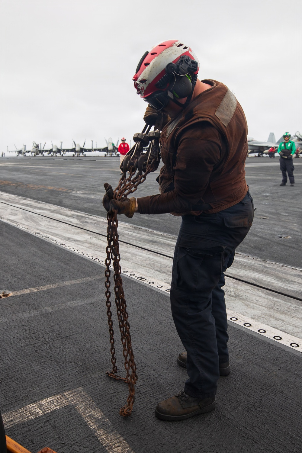 USS George H.W. Bush chains down an MH-60R Sea Hawk