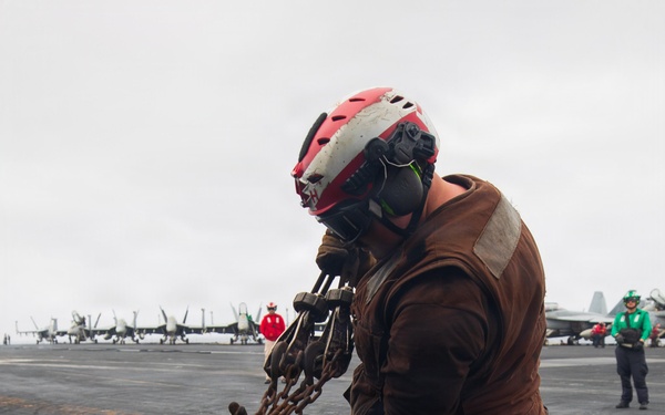USS George H.W. Bush chains down an MH-60R Sea Hawk