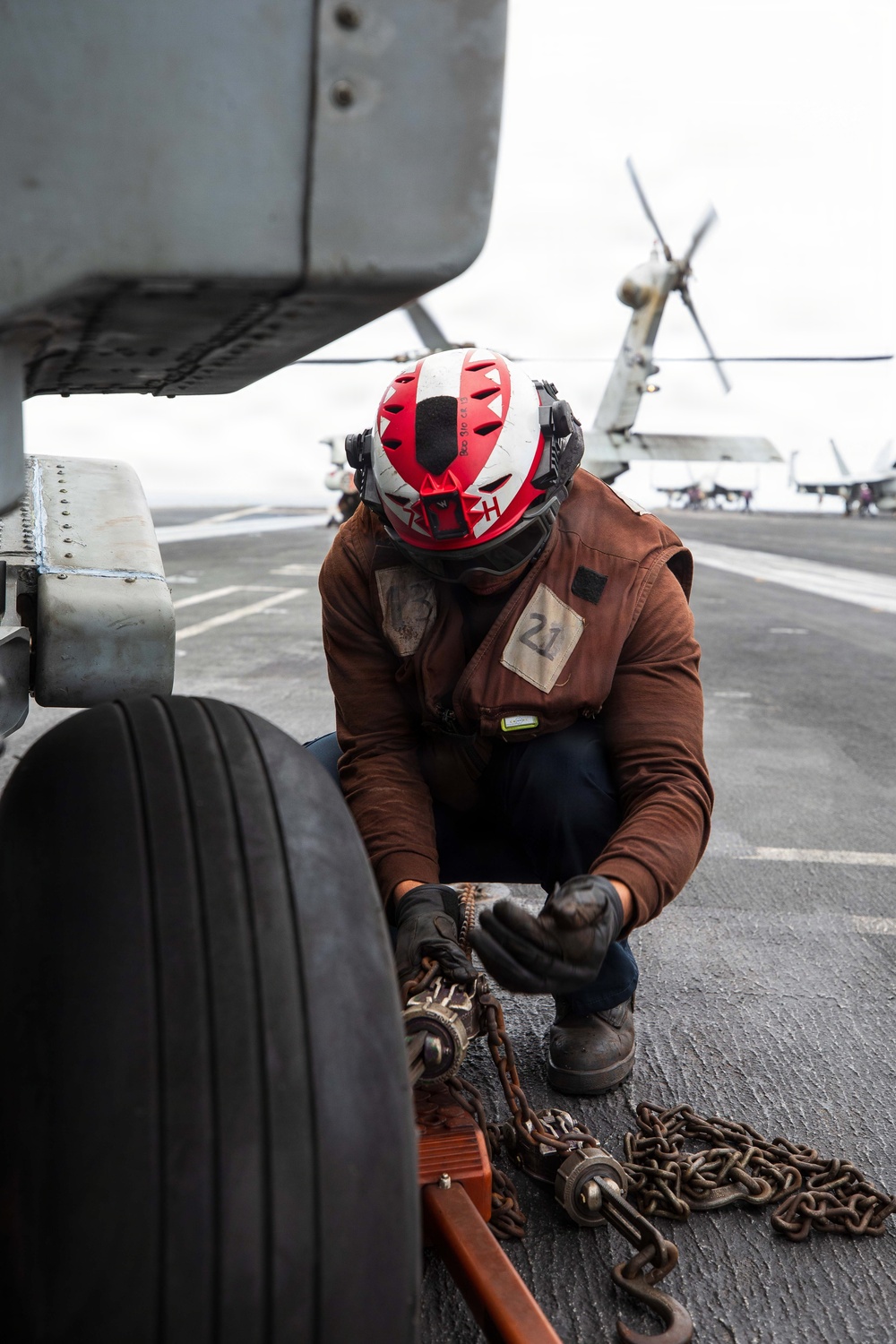 USS George H.W. Bush chains down an MH-60R Sea Hawk