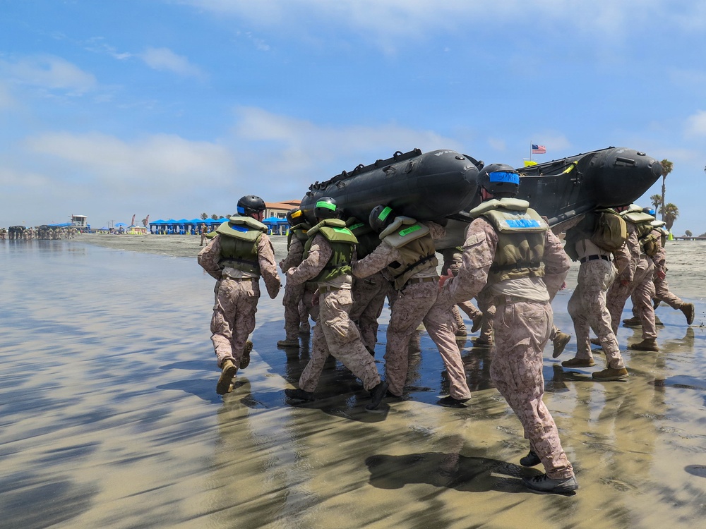 2nd Bn., 5th Marines, paddle through surf during infantry company small boat raid course