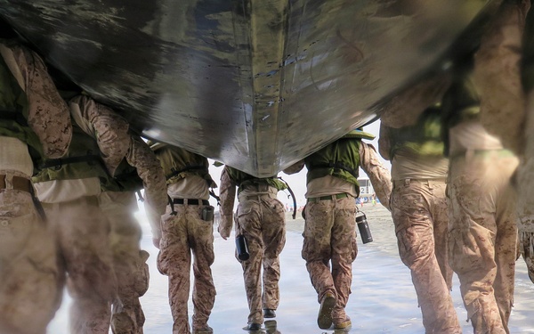 2nd Bn., 5th Marines, paddle through surf during infantry company small boat raid course