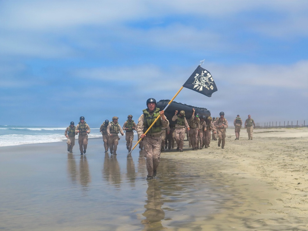 2nd Bn., 5th Marines, paddle through surf during infantry company small boat raid course