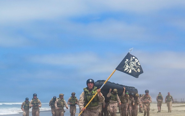 2nd Bn., 5th Marines, paddle through surf during infantry company small boat raid course