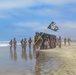 2nd Bn., 5th Marines, paddle through surf during infantry company small boat raid course