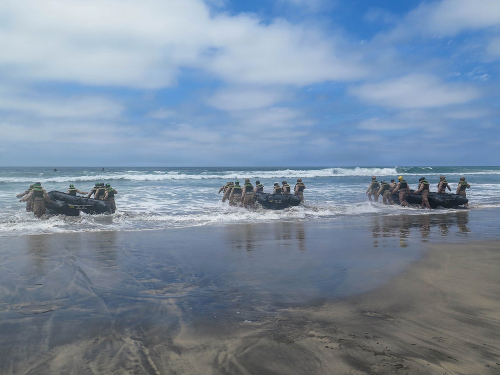 2nd Bn., 5th Marines, paddle through surf during infantry company small boat raid course