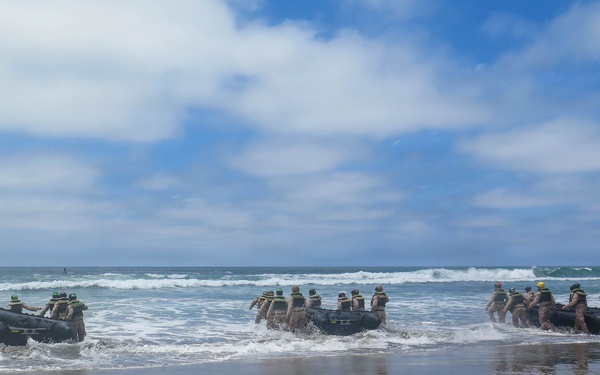 2nd Bn., 5th Marines, paddle through surf during infantry company small boat raid course