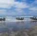 2nd Bn., 5th Marines, paddle through surf during infantry company small boat raid course