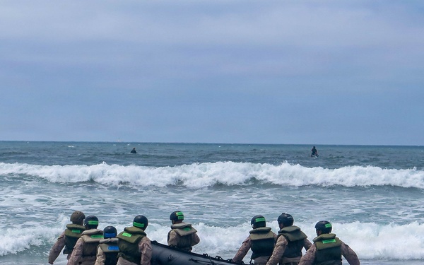 2nd Bn., 5th Marines, paddle through surf during infantry company small boat raid course
