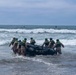 2nd Bn., 5th Marines, paddle through surf during infantry company small boat raid course