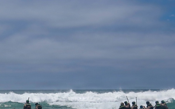 2nd Bn., 5th Marines, paddle through surf during infantry company small boat raid course