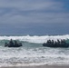 2nd Bn., 5th Marines, paddle through surf during infantry company small boat raid course