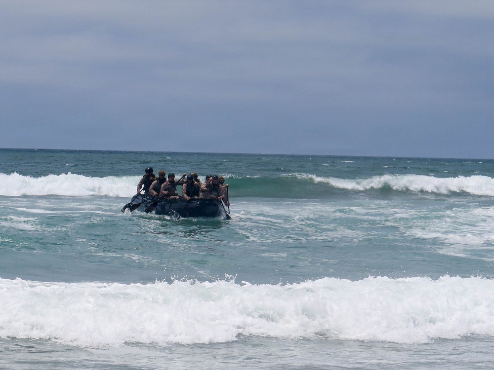 2nd Bn., 5th Marines, paddle through surf during infantry company small boat raid course