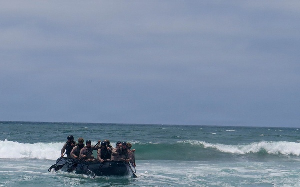 2nd Bn., 5th Marines, paddle through surf during infantry company small boat raid course