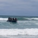 2nd Bn., 5th Marines, paddle through surf during infantry company small boat raid course