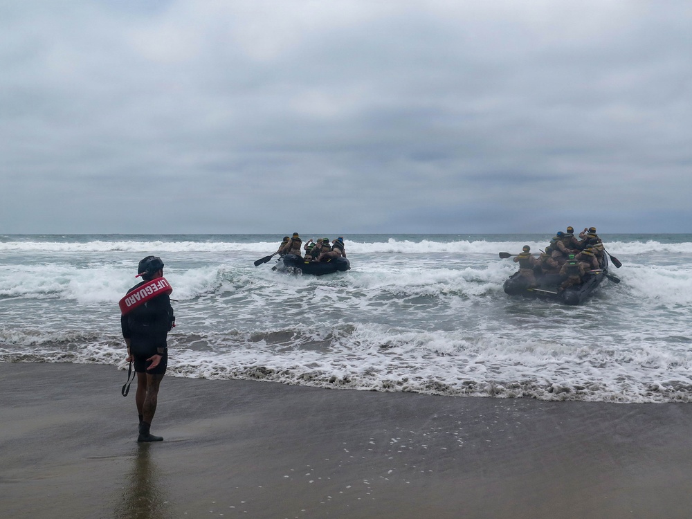 2nd Bn., 5th Marines, paddle through surf during infantry company small boat raid course