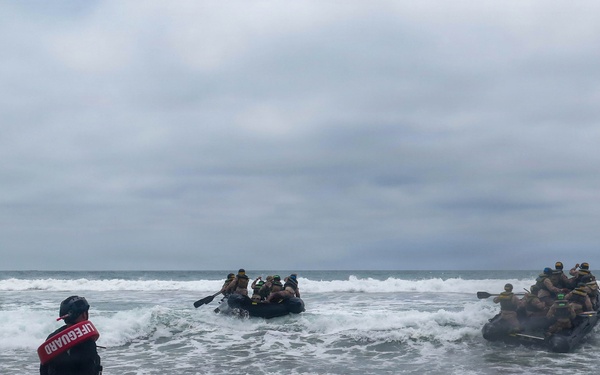 2nd Bn., 5th Marines, paddle through surf during infantry company small boat raid course