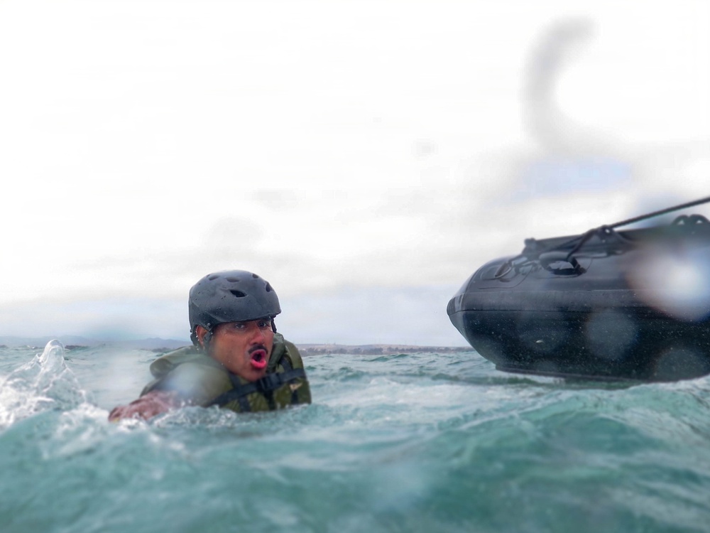 2nd Bn., 5th Marines, paddle through surf during infantry company small boat raid course