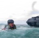 2nd Bn., 5th Marines, paddle through surf during infantry company small boat raid course