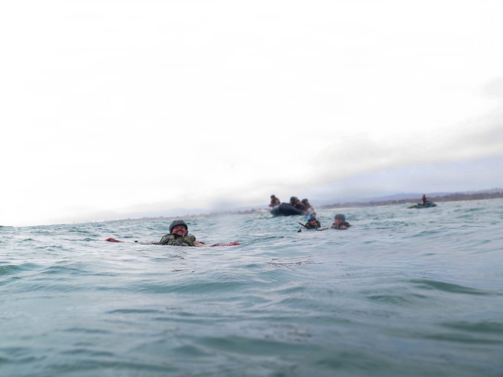 2nd Bn., 5th Marines, paddle through surf during infantry company small boat raid course