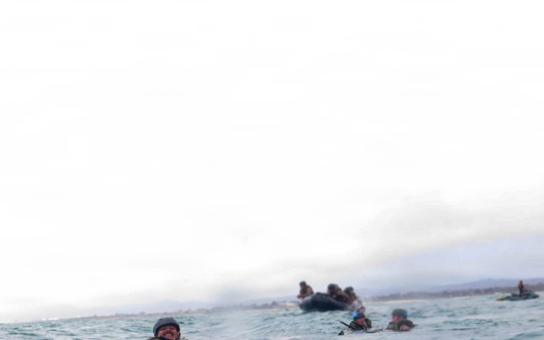 2nd Bn., 5th Marines, paddle through surf during infantry company small boat raid course
