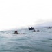 2nd Bn., 5th Marines, paddle through surf during infantry company small boat raid course