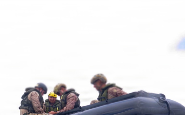 2nd Bn., 5th Marines, paddle through surf during infantry company small boat raid course
