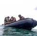 2nd Bn., 5th Marines, paddle through surf during infantry company small boat raid course