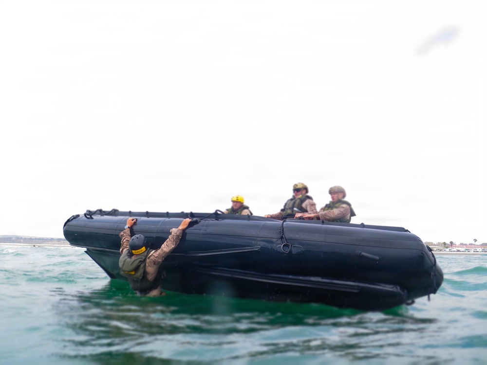 2nd Bn., 5th Marines, paddle through surf during infantry company small boat raid course