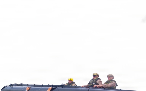 2nd Bn., 5th Marines, paddle through surf during infantry company small boat raid course