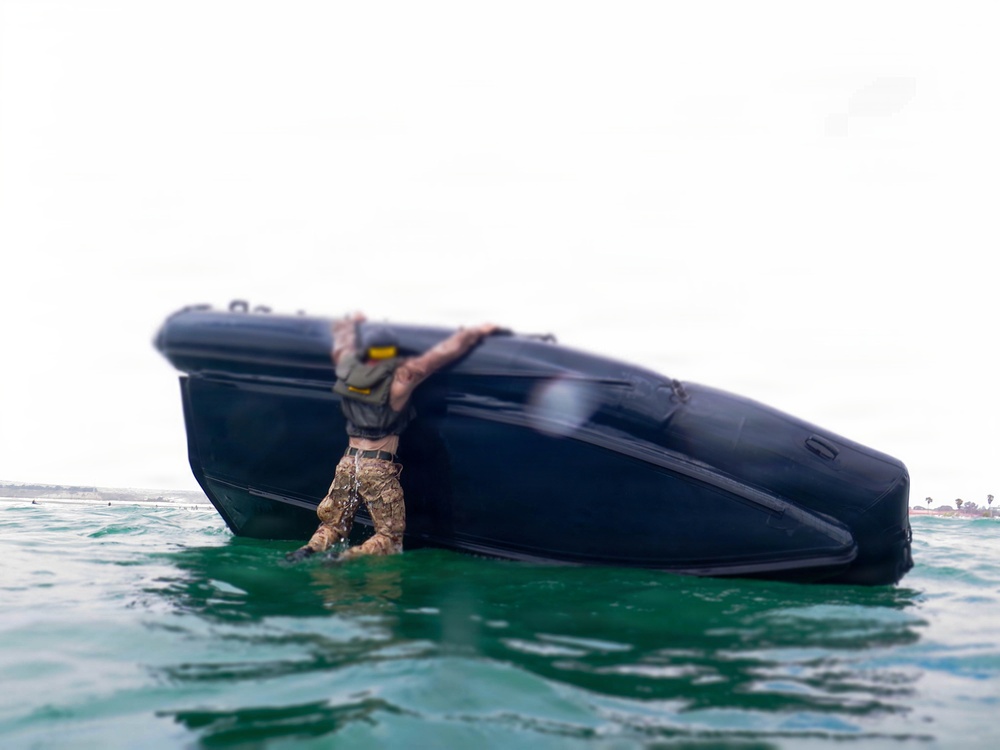2nd Bn., 5th Marines, paddle through surf during infantry company small boat raid course