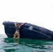 2nd Bn., 5th Marines, paddle through surf during infantry company small boat raid course