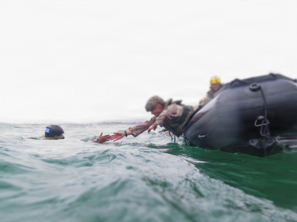 2nd Bn., 5th Marines, paddle through surf during infantry company small boat raid course