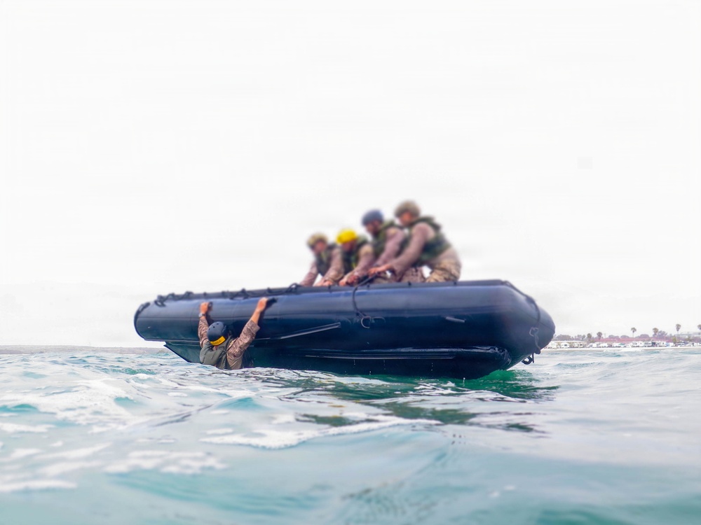 2nd Bn., 5th Marines, paddle through surf during infantry company small boat raid course