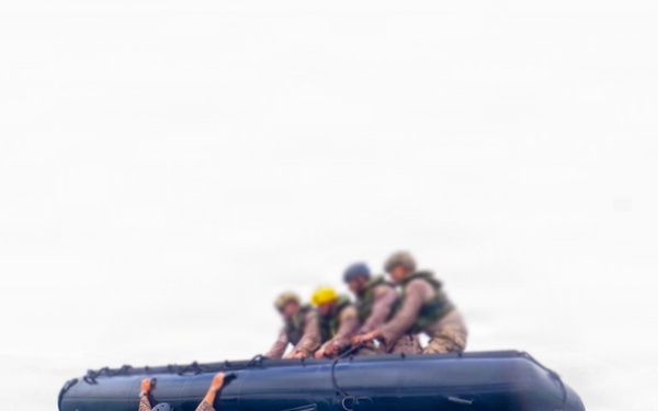 2nd Bn., 5th Marines, paddle through surf during infantry company small boat raid course