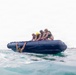 2nd Bn., 5th Marines, paddle through surf during infantry company small boat raid course