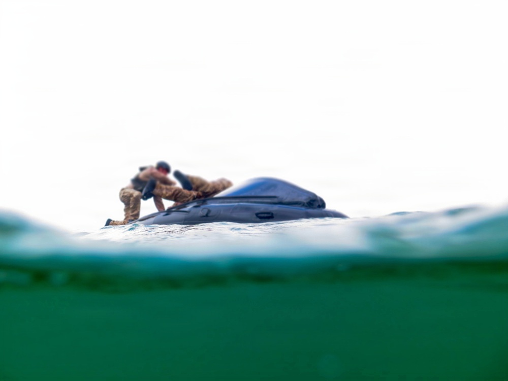 2nd Bn., 5th Marines, paddle through surf during infantry company small boat raid course